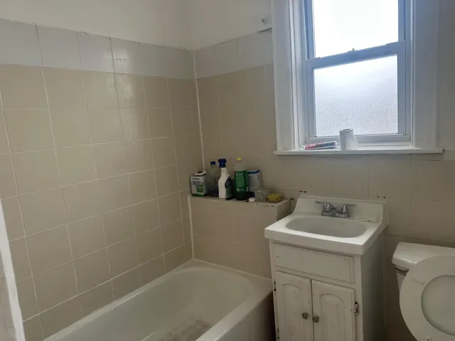 a bathroom with a sink a toilet and a shower