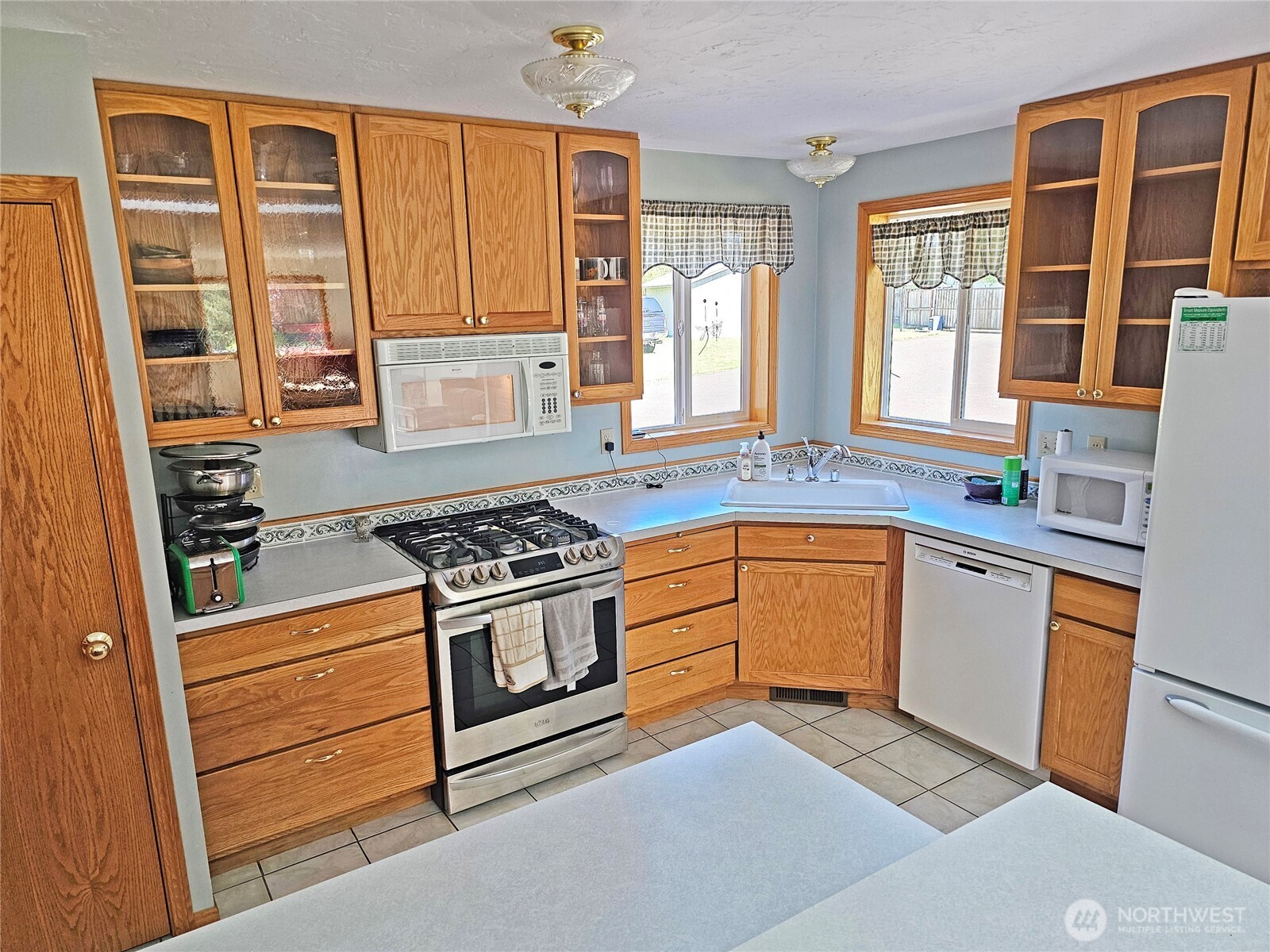 17103 Camas Run Lane Southwest Rochester, WA 98579 - Photo 7 of 40 a kitchen with stainless steel appliances granite countertop a stove and a sink