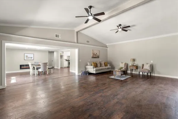 a view of a livingroom with furniture and a ceiling fan