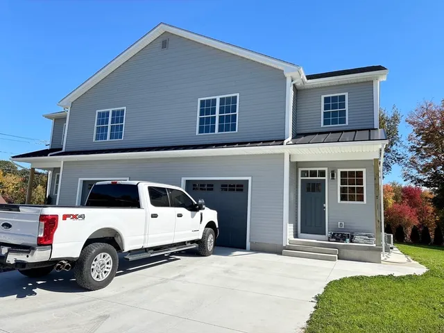 a view of a car parked front of a house