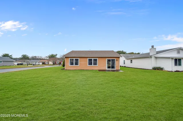 a view of a yard in front of a house with a big yard