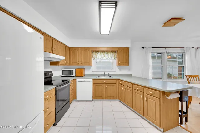 a kitchen with stainless steel appliances granite countertop a stove sink and cabinets
