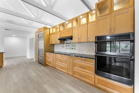 a kitchen with stainless steel appliances refrigerator and cabinets