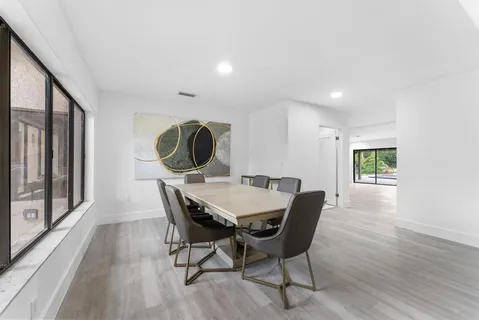 a bedroom with a bed and large glass window