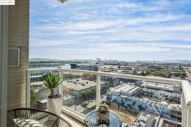 a city view from a balcony with furniture