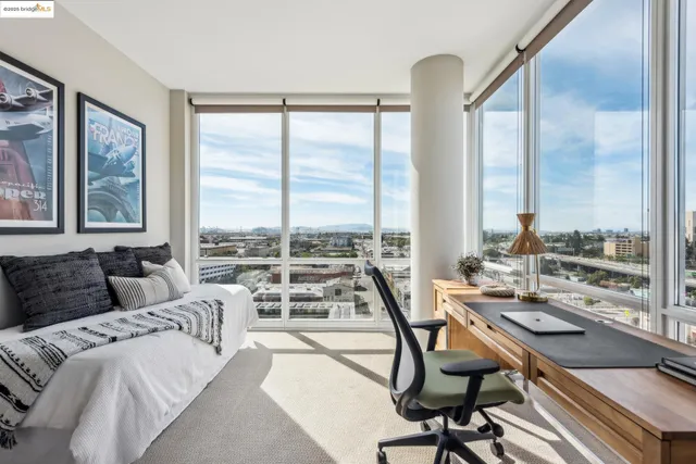 a view of a living room with furniture and floor to ceiling window
