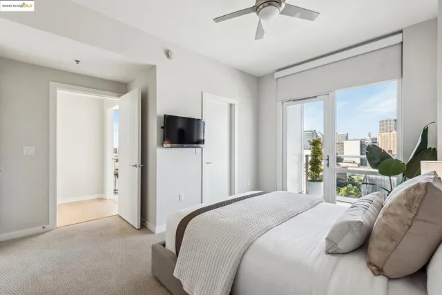 a spacious bedroom with a bed and a potted plant