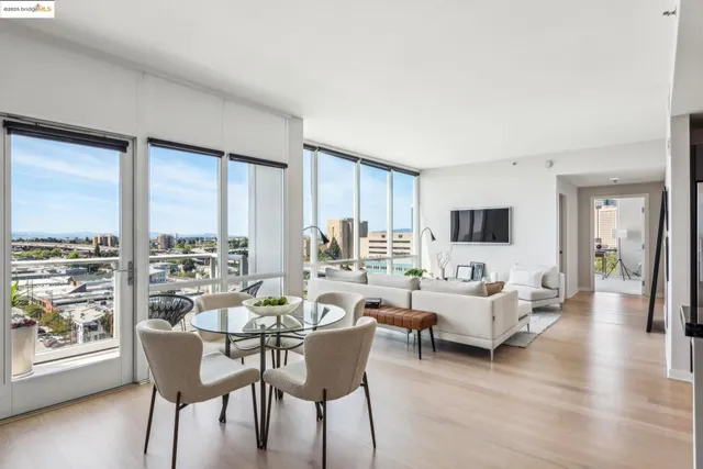 a living room with furniture large windows and a flat screen tv
