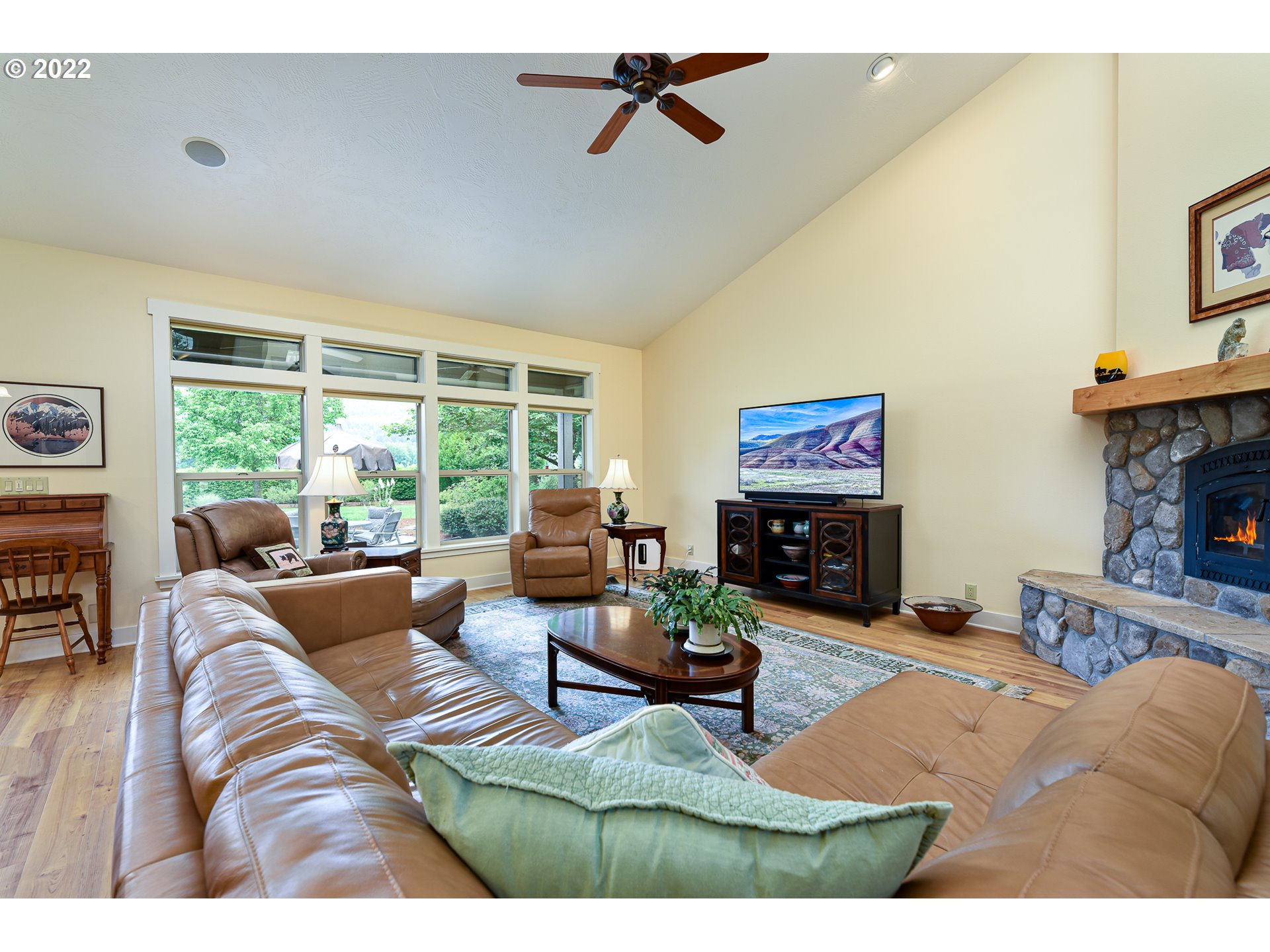90730 Marcola Road Springfield, OR 97478 - Photo 6 of 30 a living room with furniture a fireplace and a flat screen tv