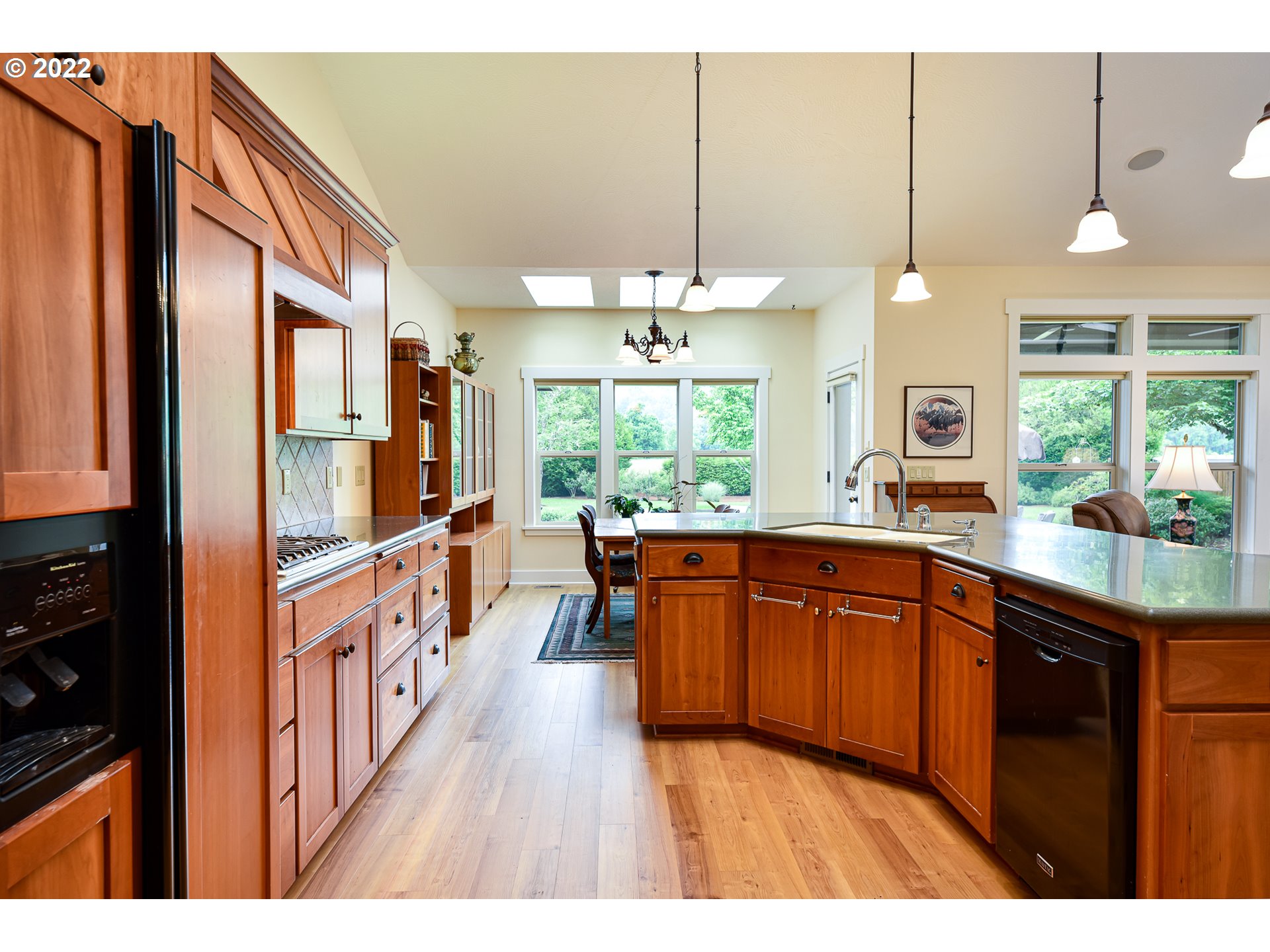 90730 Marcola Road Springfield, OR 97478 - Photo 7 of 30 a open kitchen with stainless steel appliances granite countertop a stove a sink dishwasher and a refrigerator with wooden floor