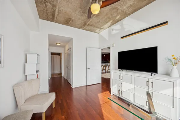 a living room with furniture and a wooden floor