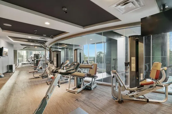 a room with gym equipment and view of living room