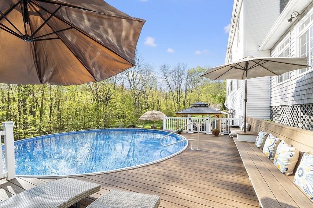 swimming pool view with a seating space