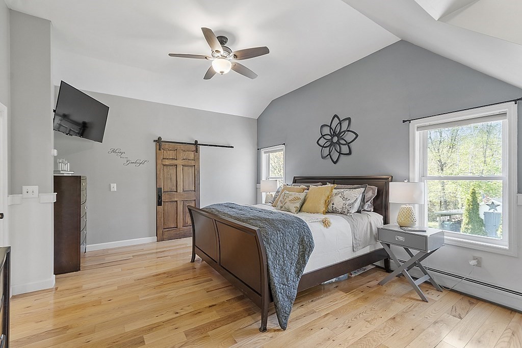 264 Hackett Hill Road Hooksett, NH 03106 - Photo 20 of 41 a spacious bedroom with a bed and a window