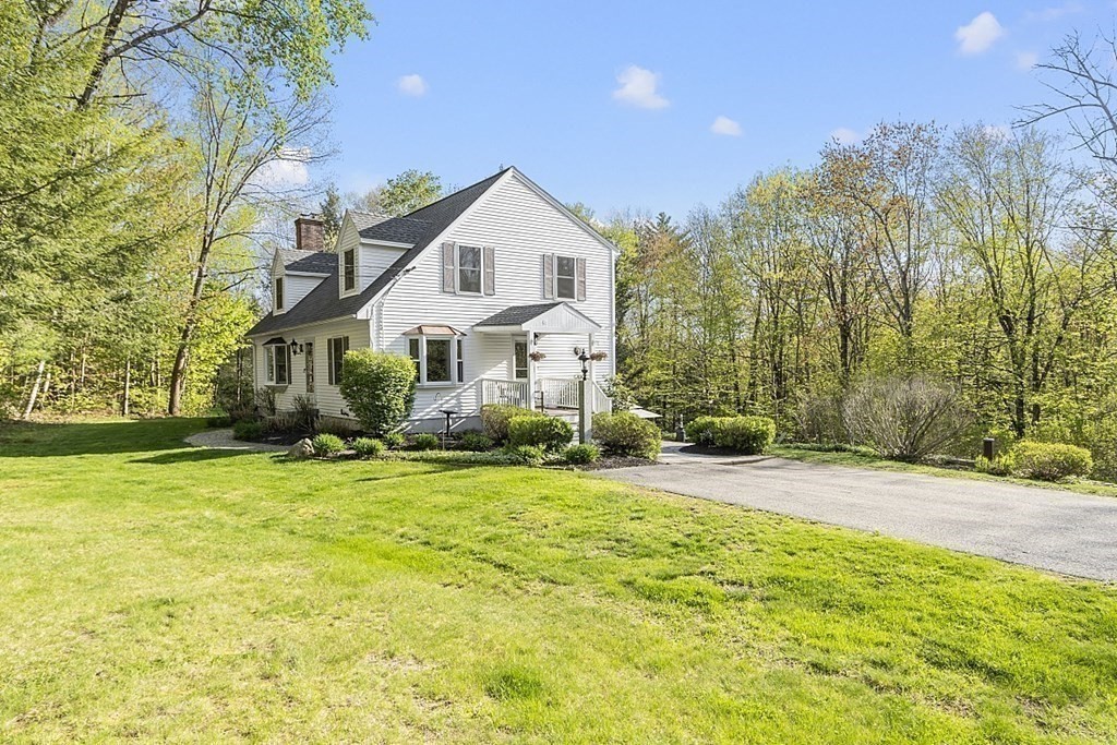 264 Hackett Hill Road Hooksett, NH 03106 - Photo 32 of 41 a front view of a house with a yard and trees