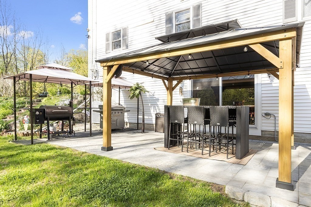 264 Hackett Hill Road Hooksett, NH 03106 - Photo 36 of 41 a view of a chairs and table in the patio