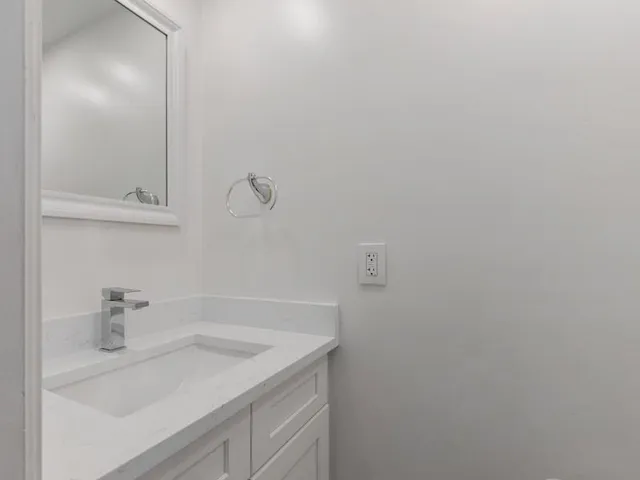 a bathroom with a sink and vanity