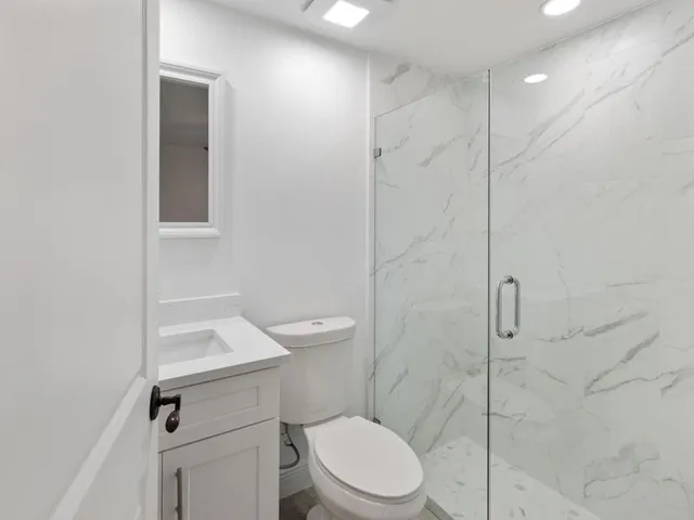 a white toilet sitting next to a bathroom sink