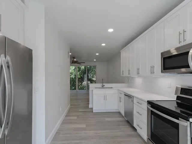 a kitchen with a sink stainless steel appliances and cabinets
