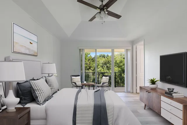 a spacious bedroom with a bed and a flat screen tv