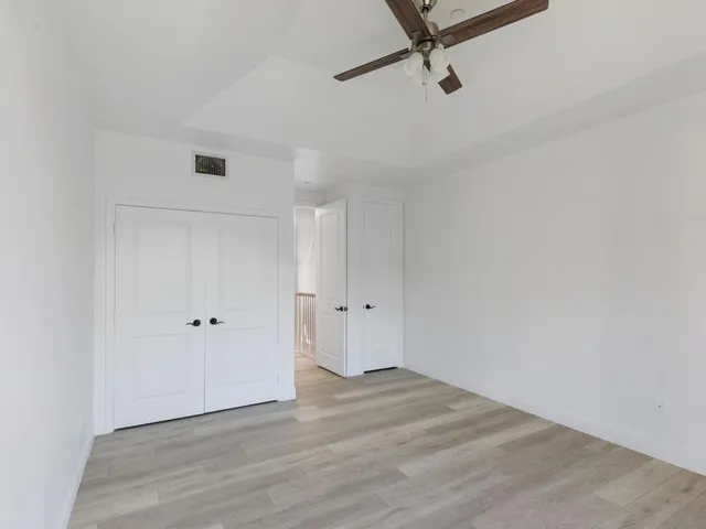 a view of a room with wooden floor and white walls