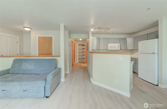 a kitchen with stainless steel appliances granite countertop a refrigerator and a stove