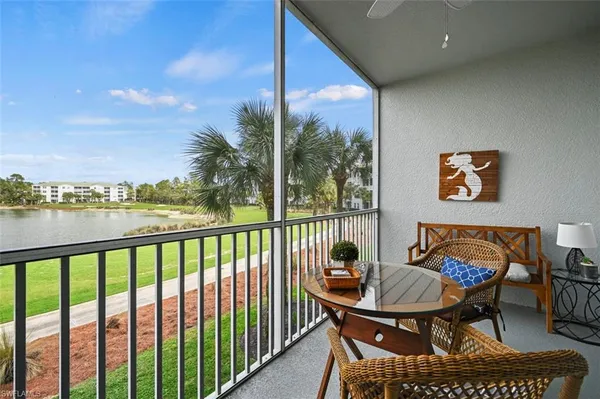 a view of a balcony with furniture and a floor to ceiling window