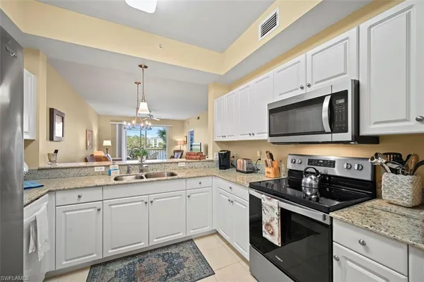 a kitchen with a sink stove and microwave