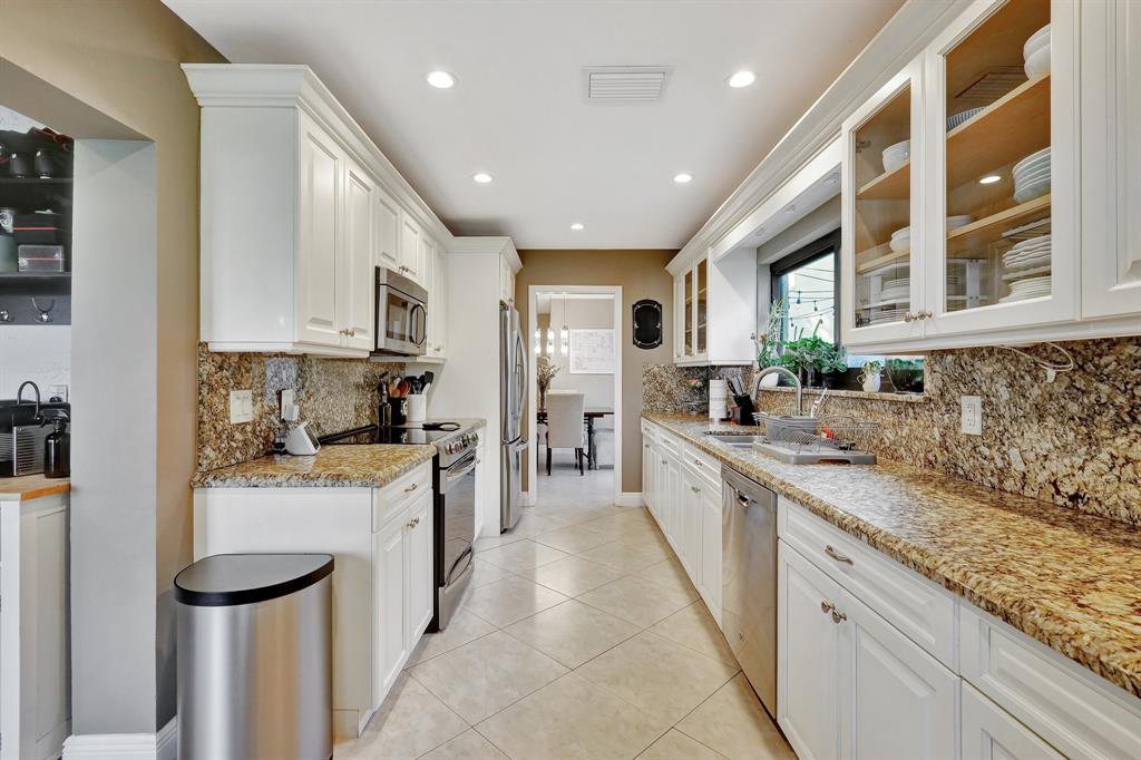 6810 Allegre Court Boca Raton, FL 33433 - Photo 14 of 29 a large kitchen with stainless steel appliances granite countertop lots of counter space and a sink