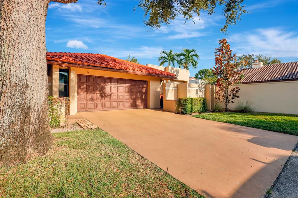 6810 Allegre Court Boca Raton, FL 33433 - Photo 2 of 29 front view of a house with a yard
