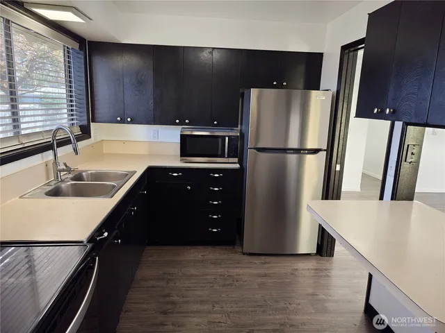 a kitchen with refrigerator and cabinets