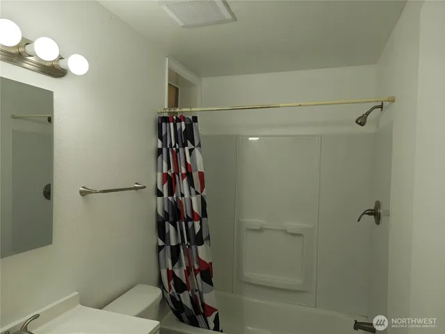 a bathroom with a shower toilet and sink