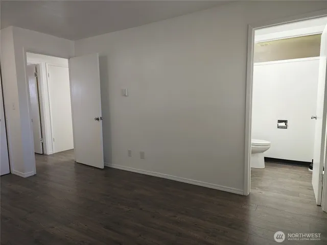 a view of a room with wooden floor
