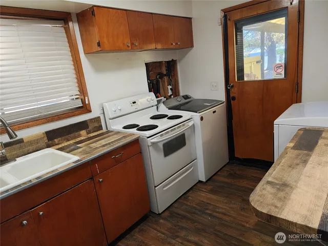 a kitchen with wooden cabinets and refrigerator
