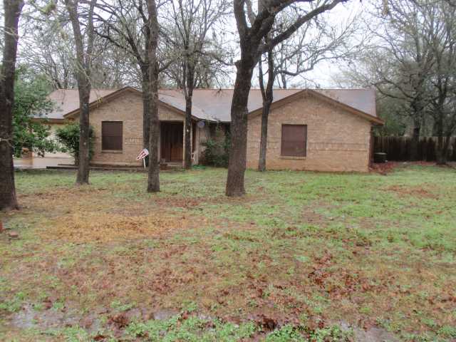1011 Quail Road Manchaca, TX 78652 - Photo 1 of 1 a house that has a tree in front of a house