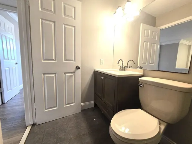 a bathroom with a toilet a sink and a mirror