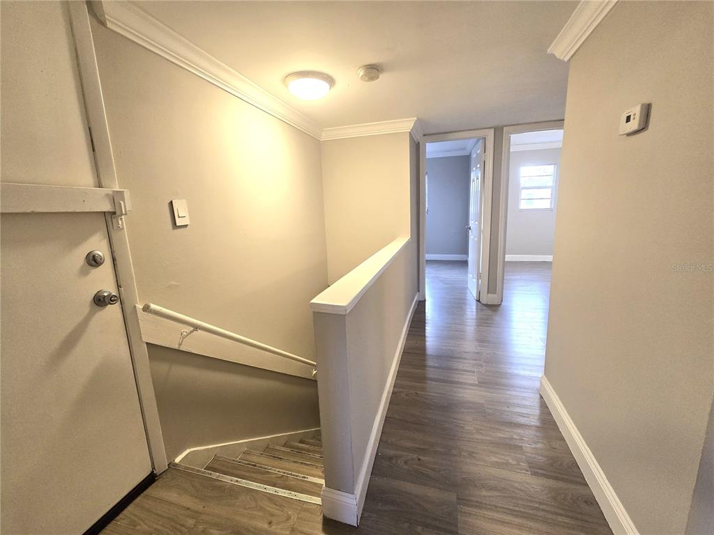 914 Southwest 8th Avenue, Unit 57 Gainesville, FL 32601 - Photo 24 of 31 a view of a hallway with wooden floor and staircase