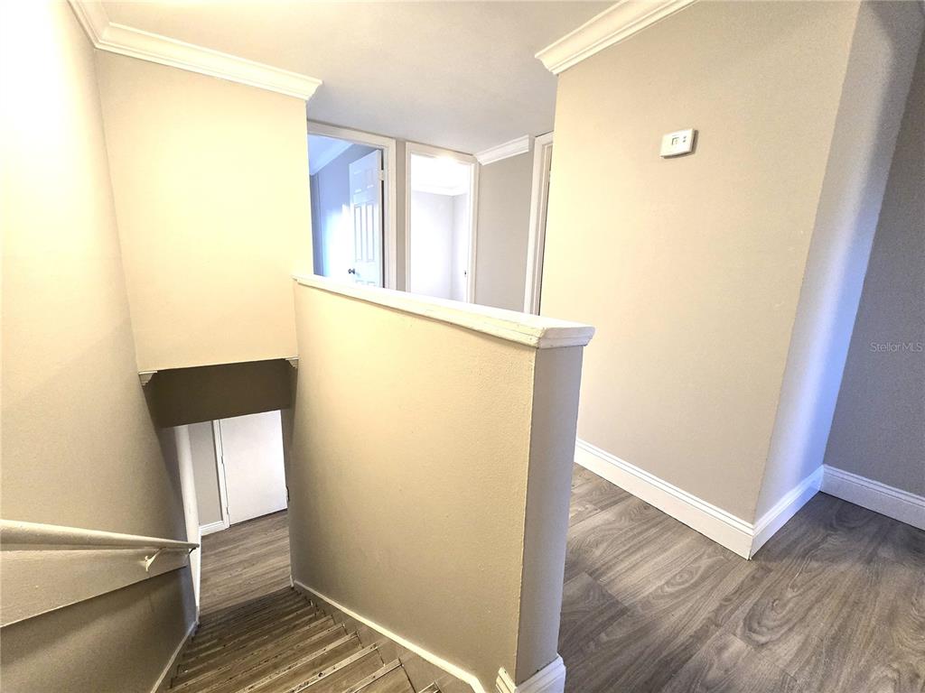 914 Southwest 8th Avenue, Unit 57 Gainesville, FL 32601 - Photo 25 of 31 a view of an empty room with wooden floor and a window