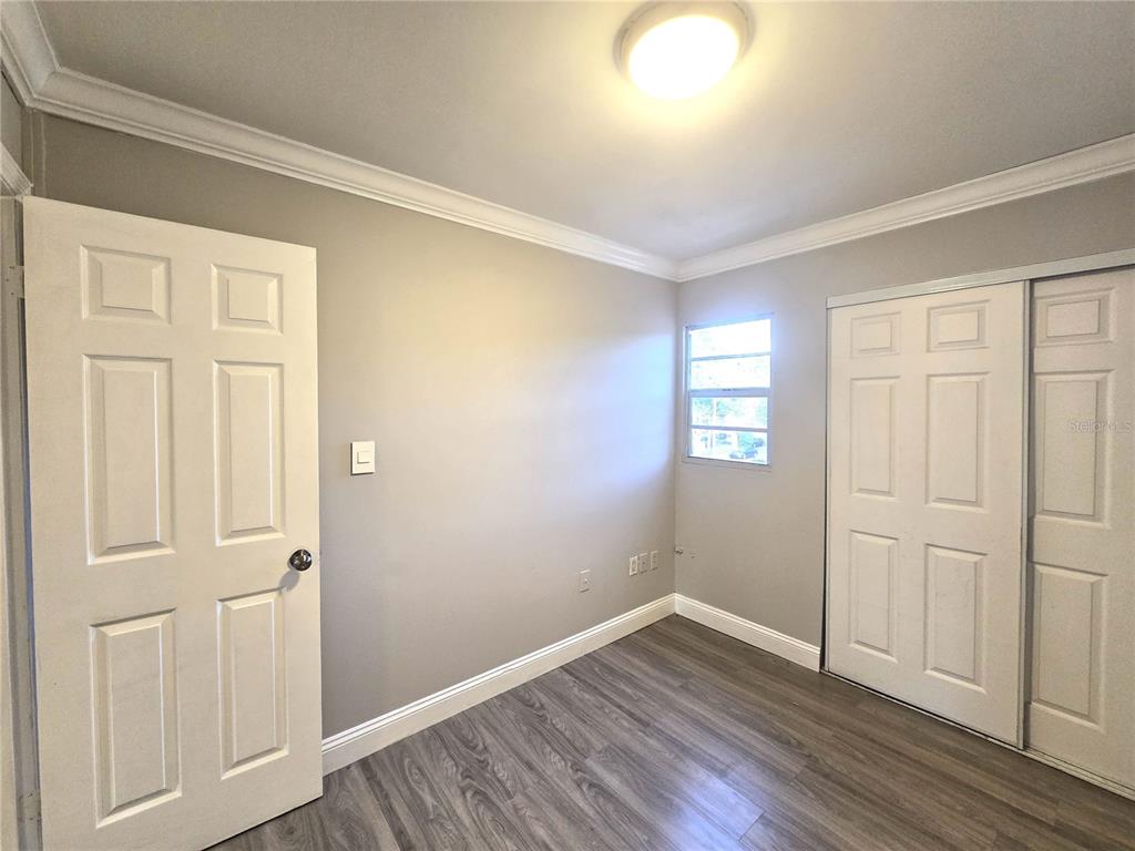 914 Southwest 8th Avenue, Unit 57 Gainesville, FL 32601 - Photo 28 of 31 a view of an empty room with wooden floor