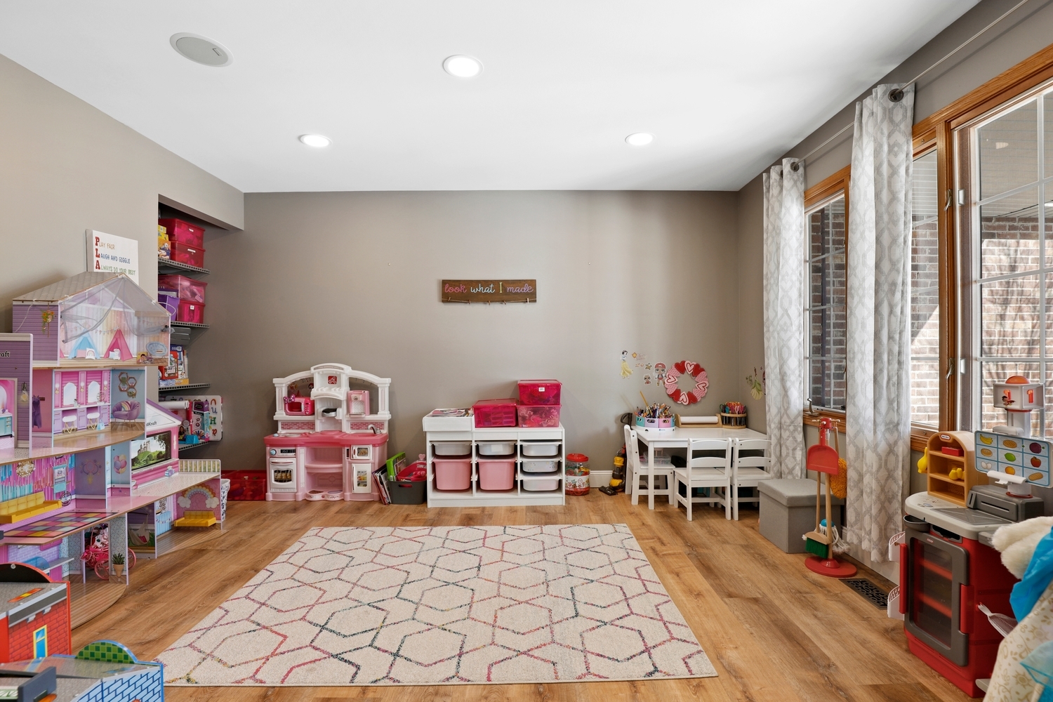 14710 Heathcliff Road Homer Glen, IL 60491 - Photo 10 of 27 a living room with furniture a baby crib and a wooden floor