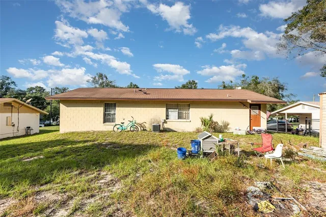a view of a yard with plants and trees