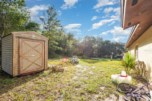 a backyard of a house with table and chairs