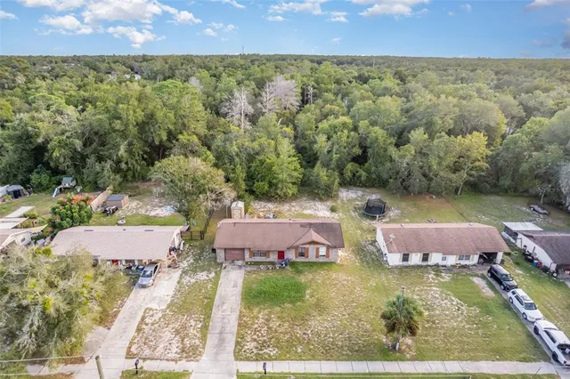 an aerial view of residential houses with outdoor space