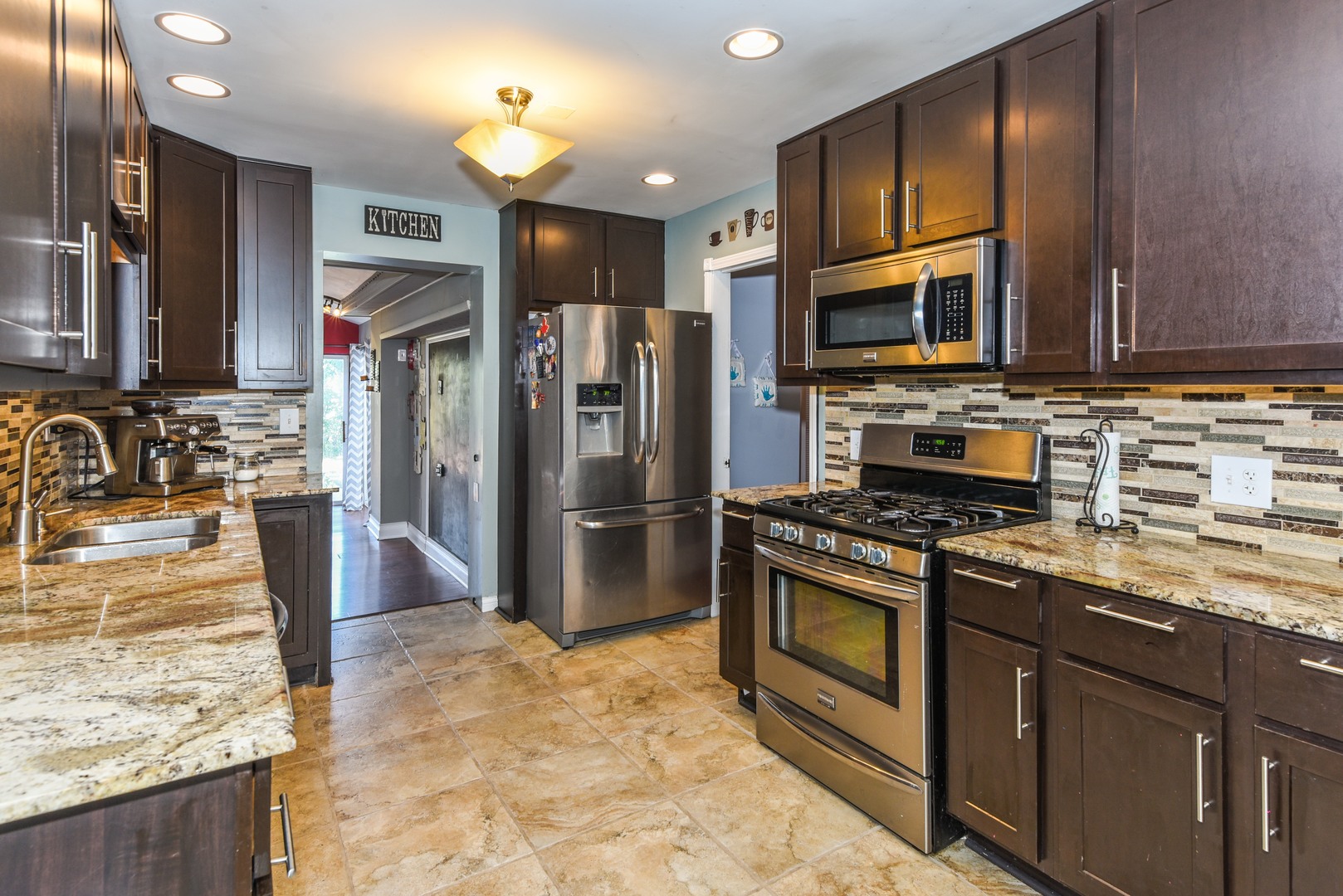 10920 Rutherford Avenue Worth, IL 60482 - Photo 5 of 15 a kitchen with stainless steel appliances granite countertop a stove refrigerator and microwave