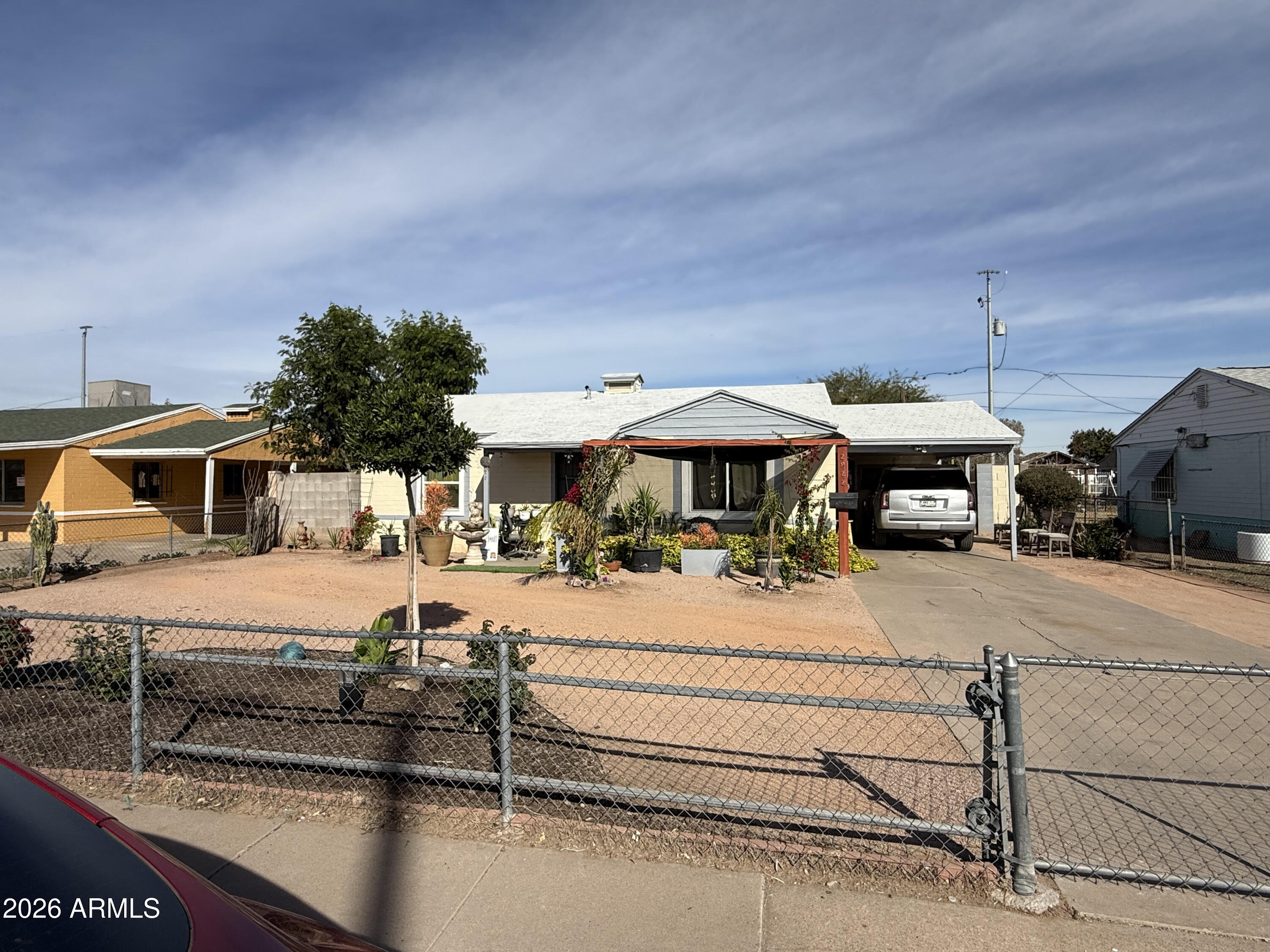 2922 West Fillmore Street Phoenix, AZ 85009 - Photo 11 of 13 a front view of a house with yard and seating area
