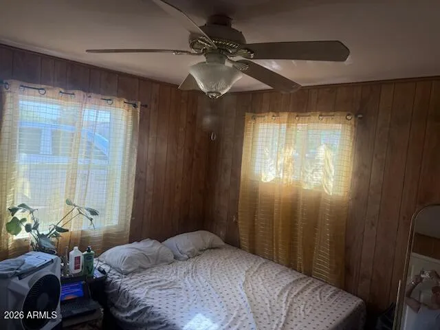 a bedroom with a bed and a chandelier