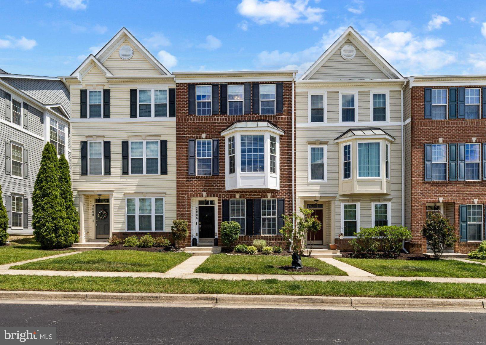 2668 Merlin Court Odenton, MD 21113 - Photo 1 of 42 a front view of a residential apartment building with a yard