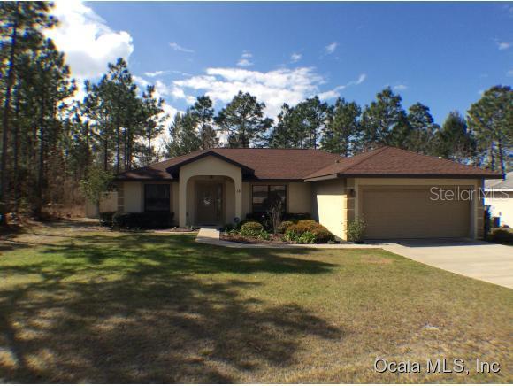 18 Hemlock Road Ocala, FL 34472 - Photo 1 of 1 a front view of a house with a yard and garage