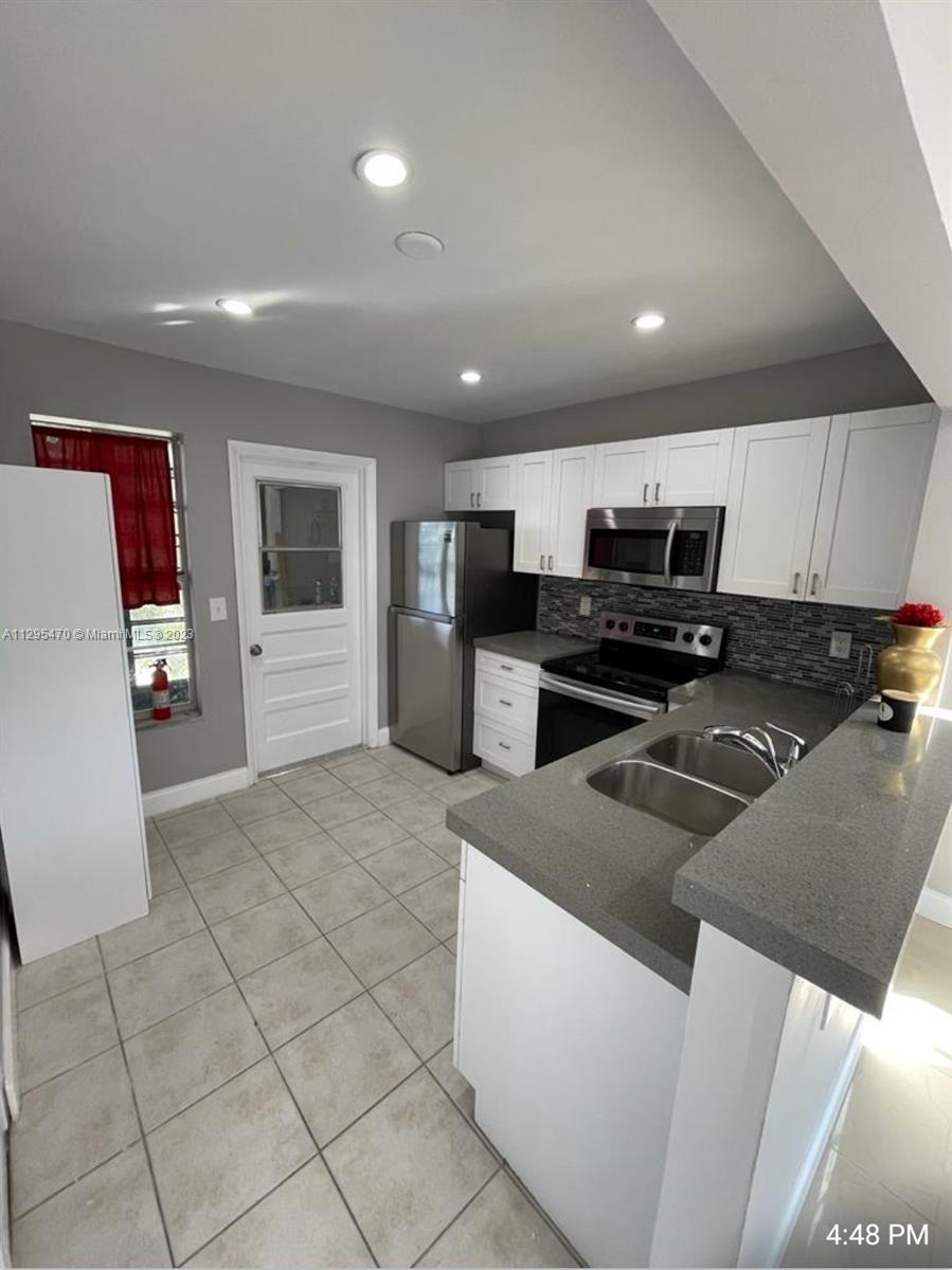 Davie Davie, FL 33024 - Photo 2 of 11 a kitchen with stainless steel appliances a refrigerator and a stove top oven