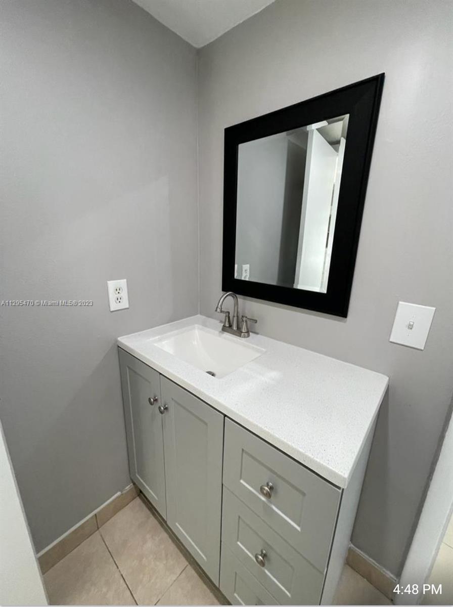Davie Davie, FL 33024 - Photo 6 of 11 a bathroom with a sink and a mirror